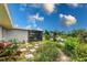 The backyard features a pond view and a screened-in patio at 2324 Hayworth Rd, Port Charlotte, FL 33952