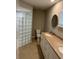 Bright bathroom with double sinks, glass block shower, and tile flooring at 2324 Hayworth Rd, Port Charlotte, FL 33952