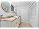 Bright bathroom featuring a double vanity, framed mirrors and plenty of storage at 2324 Hayworth Rd, Port Charlotte, FL 33952