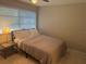 This bedroom has neutral-colored walls, carpet, and a modern bed frame at 2324 Hayworth Rd, Port Charlotte, FL 33952
