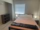 This bedroom features a modern bed frame, closet, and neutral color paint at 2324 Hayworth Rd, Port Charlotte, FL 33952