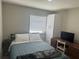 This bedroom features a closet, desk, and a modern bed frame at 2324 Hayworth Rd, Port Charlotte, FL 33952