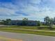 A neatly landscaped single-story home with a well-manicured lawn and a tidy exterior view at 2324 Hayworth Rd, Port Charlotte, FL 33952