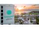 A resort view with palm trees and manicured landscaping, all set against a stunning sunset over the water at 2324 Hayworth Rd, Port Charlotte, FL 33952