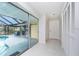 Hallway leading to an enclosed porch and pool area, with multiple storage closets at 2324 Hayworth Rd, Port Charlotte, FL 33952
