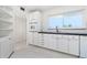 Bright kitchen boasts white cabinetry, tiled floors, and modern appliances at 2324 Hayworth Rd, Port Charlotte, FL 33952