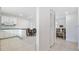 Open-concept space showcases a kitchen with white cabinetry, a dining area, and a glimpse of a living space at 2324 Hayworth Rd, Port Charlotte, FL 33952