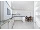 Spacious kitchen and dining area featuring sleek white cabinets, modern appliances, and tile flooring at 2324 Hayworth Rd, Port Charlotte, FL 33952