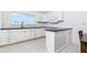 Bright kitchen featuring white cabinetry, a dark countertop, tile flooring and a window providing natural light at 2324 Hayworth Rd, Port Charlotte, FL 33952