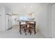 Eat-in kitchen featuring a dining table, white cabinetry, and tile floors at 2324 Hayworth Rd, Port Charlotte, FL 33952