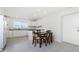 Bright eat-in kitchen featuring a dining table, white cabinets, and a window for natural light at 2324 Hayworth Rd, Port Charlotte, FL 33952