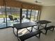 Enclosed patio with tile flooring, picnic tables, and a view of the water at 2324 Hayworth Rd, Port Charlotte, FL 33952