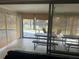 Enclosed patio with tile flooring, picnic tables, and a view of the water at 2324 Hayworth Rd, Port Charlotte, FL 33952
