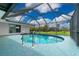 Enclosed pool and outdoor area with a beautiful view of the landscaping at 2324 Hayworth Rd, Port Charlotte, FL 33952