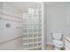 Bathroom featuring a tiled shower with glass block partition and neutral tones at 2324 Hayworth Rd, Port Charlotte, FL 33952