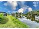 Beautiful view from the property showcasing a picturesque waterway lined with lush greenery at 2324 Hayworth Rd, Port Charlotte, FL 33952