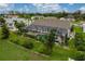 Aerial view of backyard pool and lanai bordered by manicured landscaping at 23420 Peachland Blvd, Port Charlotte, FL 33954