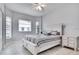 Charming bedroom featuring a queen bed, tiled floor, and two windows with blinds at 23420 Peachland Blvd, Port Charlotte, FL 33954