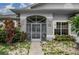 Charming front entrance with a decorative security gate and well-maintained landscaping at 23420 Peachland Blvd, Port Charlotte, FL 33954
