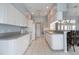 Bright kitchen featuring white cabinetry, modern appliances, and a breakfast bar at 23420 Peachland Blvd, Port Charlotte, FL 33954