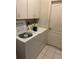 Functional laundry area with overhead cabinets and a washer and dryer at 23420 Peachland Blvd, Port Charlotte, FL 33954
