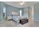 Bright main bedroom featuring a ceiling fan, tile floors, and ensuite bathroom entrance at 23420 Peachland Blvd, Port Charlotte, FL 33954