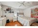 Cozy bedroom with light walls, wood floors, shelving, and modern decor at 2507 Mooring Ln, Sarasota, FL 34231