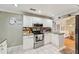 Bright kitchen with stainless steel appliances, white cabinetry, and tiled backsplash at 2507 Mooring Ln, Sarasota, FL 34231