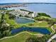 Aerial view of a condo community with lakes, golf course, and scenic waterfront views at 2615 Cove Cay Dr # 409, Clearwater, FL 33760