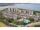 This aerial view showcases a condominium complex with a sparkling community pool near the beautiful waterfront at 2615 Cove Cay Dr # 409, Clearwater, FL 33760