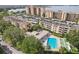 Scenic aerial shot of condos featuring a pool, lounge area, and recreation facilities at 2615 Cove Cay Dr # 409, Clearwater, FL 33760
