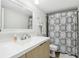 Well-lit bathroom with a decorative shower curtain and a sleek, modern vanity at 2615 Cove Cay Dr # 409, Clearwater, FL 33760