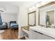 Bright bathroom vanity with double mirrors, modern lighting, and seamless flow to the bedroom at 2615 Cove Cay Dr # 409, Clearwater, FL 33760
