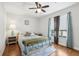 The bedroom features hardwood floors, a ceiling fan, and a window at 2615 Cove Cay Dr # 409, Clearwater, FL 33760