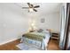 The bedroom features hardwood floors, a ceiling fan, and a window at 2615 Cove Cay Dr # 409, Clearwater, FL 33760