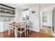 Dining room with a wood table, white chairs, and built-in shelves at 2615 Cove Cay Dr # 409, Clearwater, FL 33760
