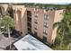 Exterior view of a condominium featuring a balcony and ample parking at 2615 Cove Cay Dr # 409, Clearwater, FL 33760