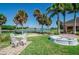 Well maintained backyard with white seating, brick walkway, and a water fountain at 2615 Cove Cay Dr # 409, Clearwater, FL 33760