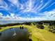 Scenic golf course view featuring a tranquil lake with fountain and vibrant green fairways at 2615 Cove Cay Dr # 409, Clearwater, FL 33760