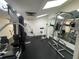 Bright gym boasts modern weightlifting equipment and mirror, perfect for a complete workout session at 2615 Cove Cay Dr # 409, Clearwater, FL 33760