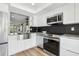 This remodeled kitchen features stainless steel appliances, granite counters and opens to the living area at 2615 Cove Cay Dr # 409, Clearwater, FL 33760