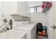 Functional laundry room with sink, washer, dryer, storage cabinets and bonus storage shelf at 2615 Cove Cay Dr # 409, Clearwater, FL 33760
