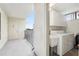 Practical laundry room with washer, dryer, sink, and balcony access for added convenience at 2615 Cove Cay Dr # 409, Clearwater, FL 33760