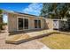 Home featuring a wood deck, an outdoor shower, and access to the backyard at 2728 58Th S St, Gulfport, FL 33707
