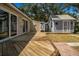 Backyard view of wooden deck, sheds, and professional landscaping at 2728 58Th S St, Gulfport, FL 33707