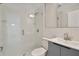 Modern bathroom with glass shower, grey vanity, and decorative tile at 2728 58Th S St, Gulfport, FL 33707