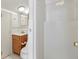 This well-lit bathroom features a wood vanity and a shower with a door at 2728 58Th S St, Gulfport, FL 33707