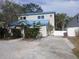 Exterior angle shot with a driveway and partial fencing; property has a unique facade and architectural detail at 2728 58Th S St, Gulfport, FL 33707