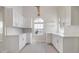 Bright kitchen with white cabinetry, quartz countertops, and sleek tile flooring, creating a modern and functional cooking space at 2728 58Th S St, Gulfport, FL 33707