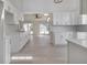 Open-concept kitchen with white cabinets and modern lighting flows into the dining area at 2728 58Th S St, Gulfport, FL 33707